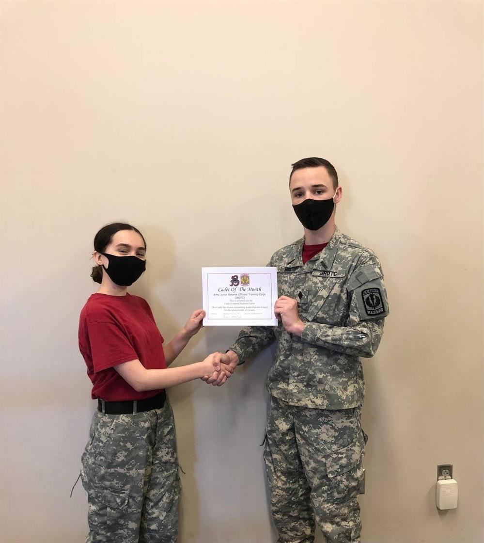XO, Davis Genery, shaking hands with the Cadet of the Month, Xadrien Carter.